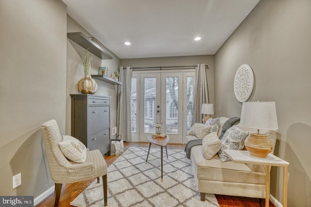 living area featuring light wood-type flooring and french doors