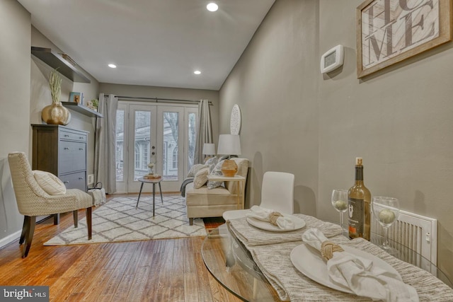 sitting room featuring french doors and light hardwood / wood-style flooring