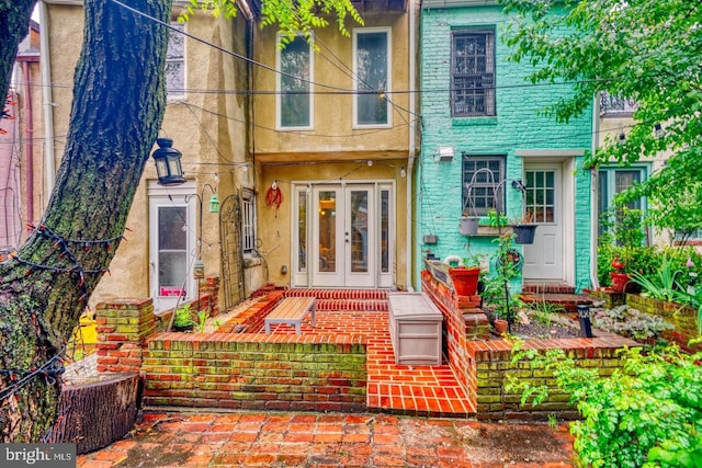 view of exterior entry featuring french doors