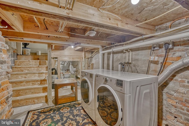 clothes washing area with washing machine and clothes dryer