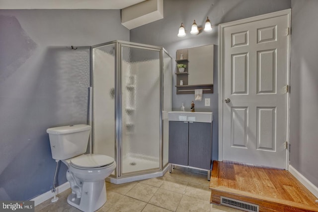 bathroom with walk in shower, sink, tile patterned flooring, and toilet