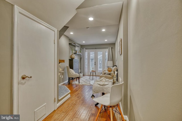 sitting room with light hardwood / wood-style flooring and french doors