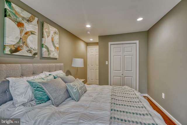 bedroom featuring hardwood / wood-style floors and a closet