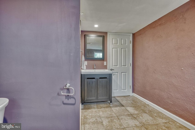 510 Druid Hill Ave, Baltimore, MD 21201 - bathroom featuring baseboards, vanity, toilet, and a textured wall