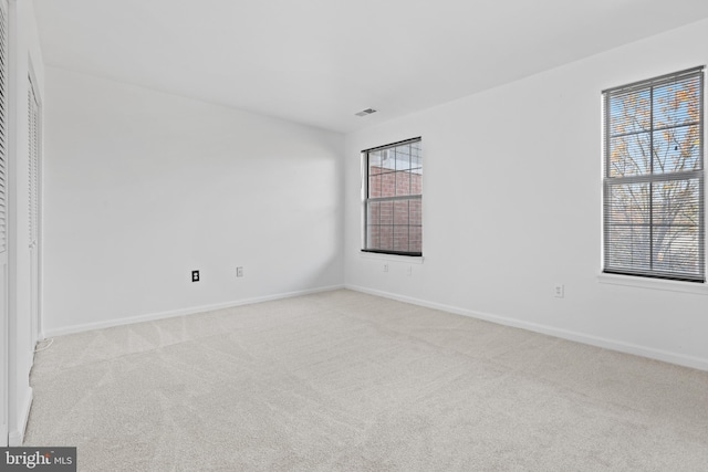 spare room with light colored carpet