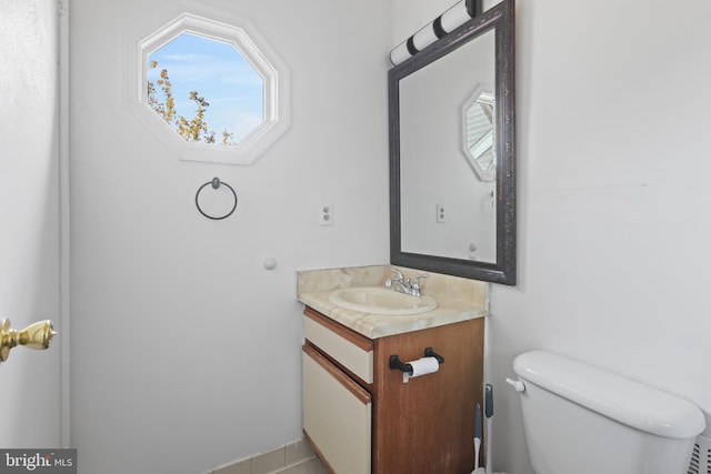 bathroom featuring tile patterned floors, vanity, and toilet