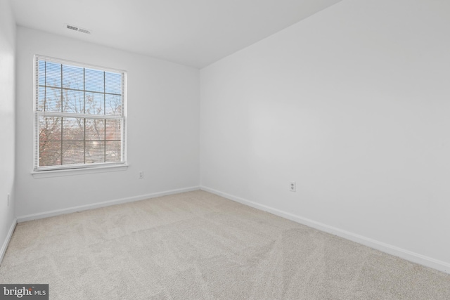 unfurnished room with light colored carpet