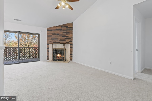 unfurnished living room with ceiling fan, light colored carpet, lofted ceiling, and a tiled fireplace