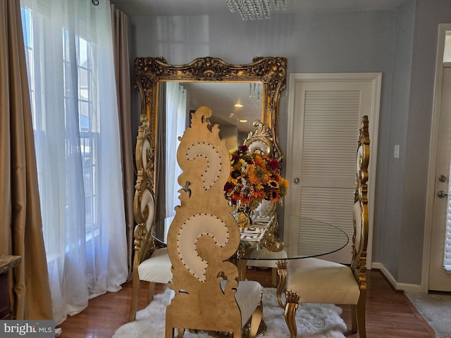 dining room with wood-type flooring and a chandelier