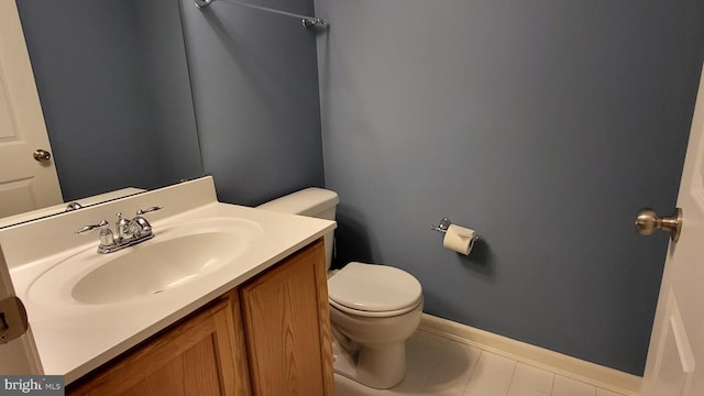 bathroom featuring tile patterned floors, vanity, and toilet