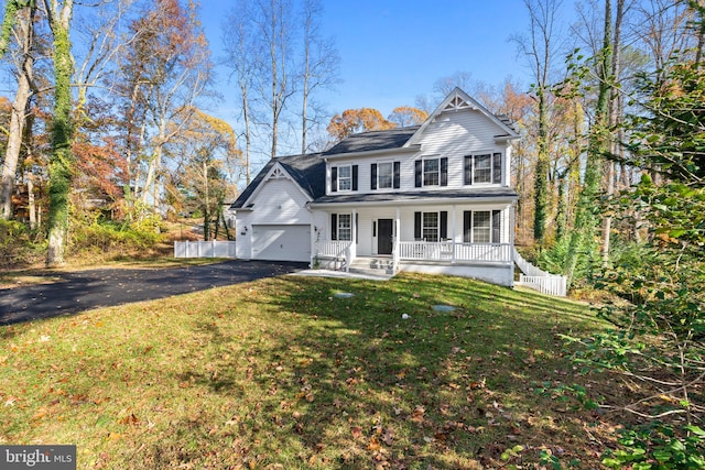 view of front facade featuring a front yard, a porch, and a garage