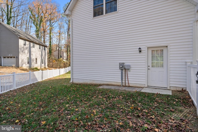 view of side of home with a lawn