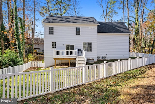 exterior space with a deck and a lawn