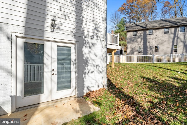 doorway to property featuring a lawn and french doors