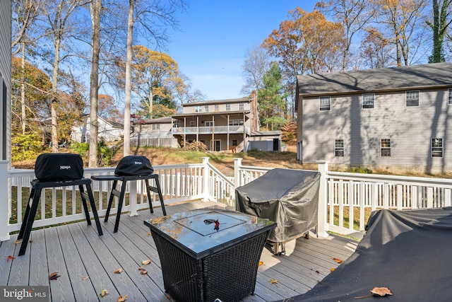 wooden terrace featuring area for grilling