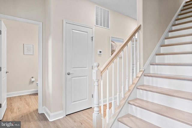 stairs featuring hardwood / wood-style flooring