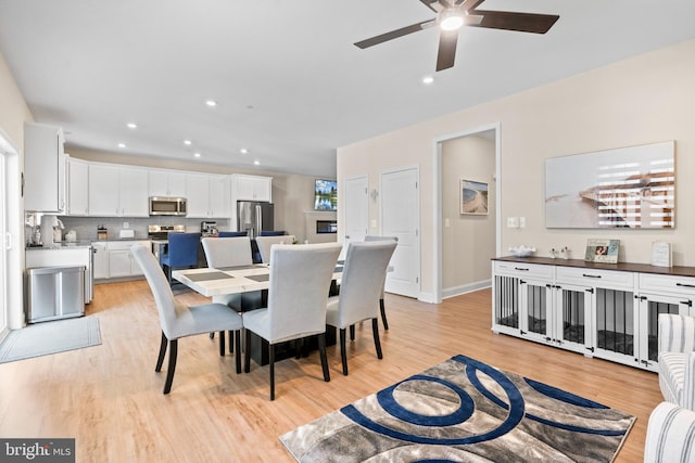 dining room featuring ceiling fan and light wood-type flooring