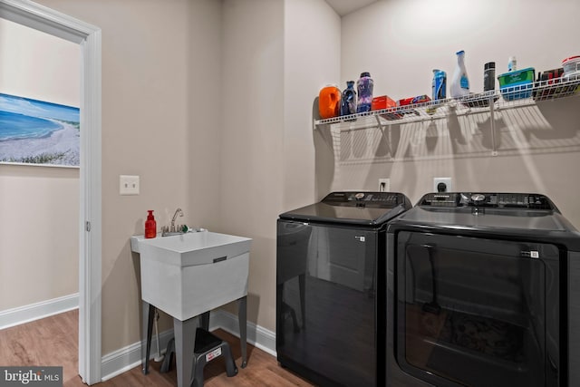 washroom featuring hardwood / wood-style floors and independent washer and dryer