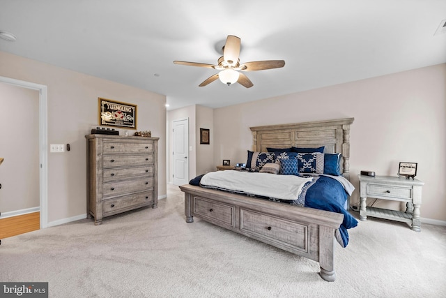 bedroom with ceiling fan and light colored carpet