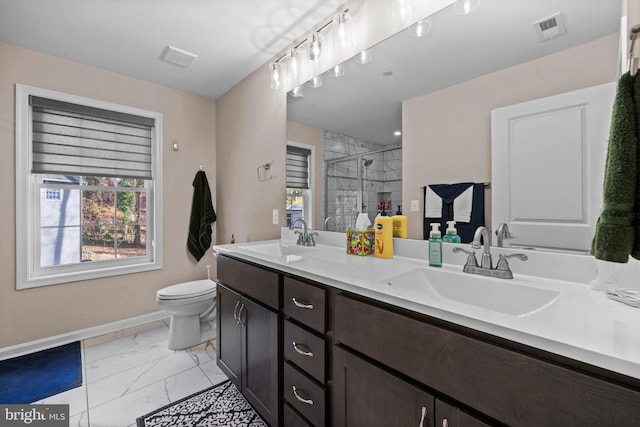 bathroom with an enclosed shower, vanity, toilet, and plenty of natural light