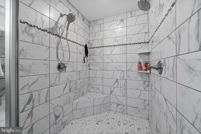 bathroom with tiled shower