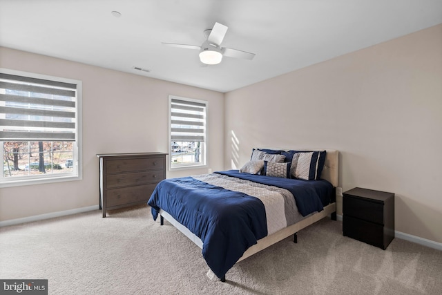 bedroom featuring light carpet and ceiling fan