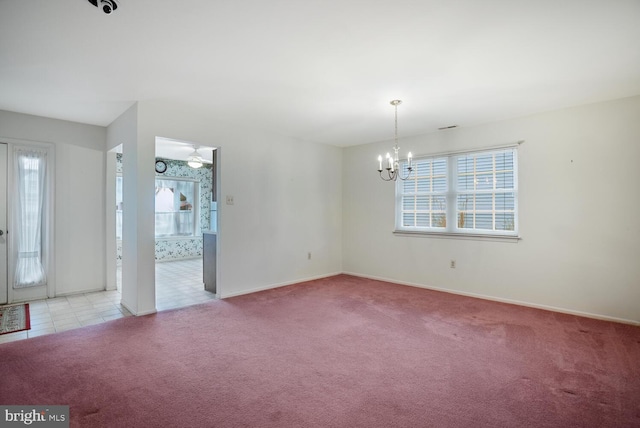 unfurnished room with ceiling fan with notable chandelier and light carpet