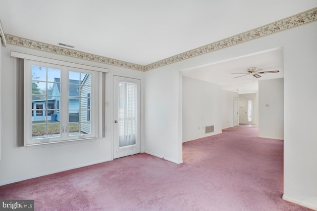 empty room featuring carpet floors and ceiling fan