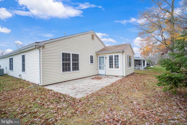 rear view of house with central AC, a sunroom, and a patio area