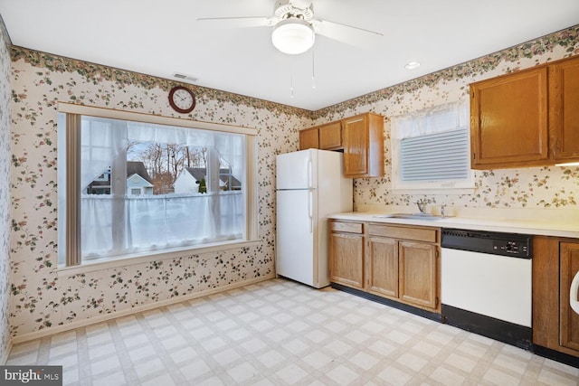 kitchen featuring ceiling fan, sink, and white appliances