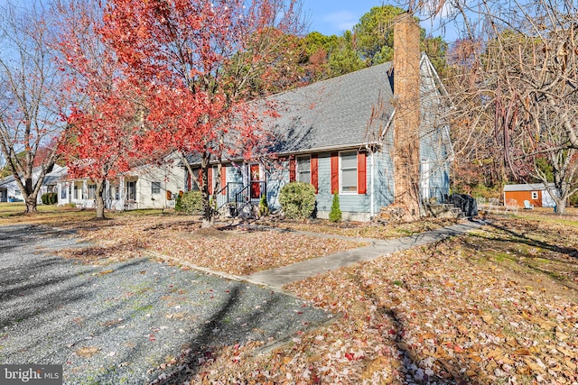 new england style home featuring a storage unit