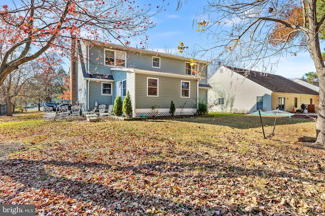 back of house with a yard