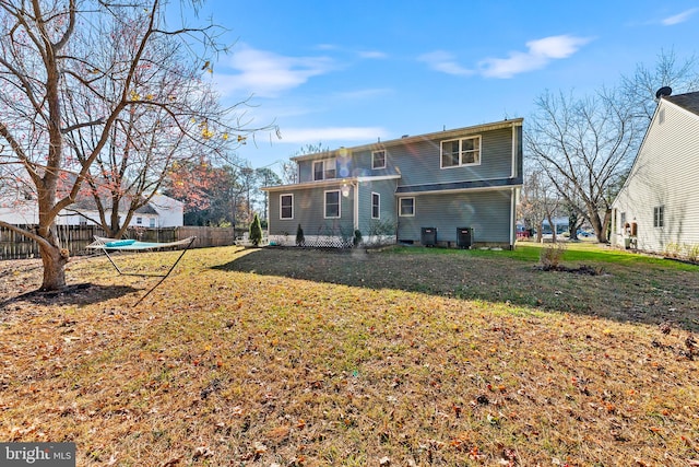 back of house with a lawn