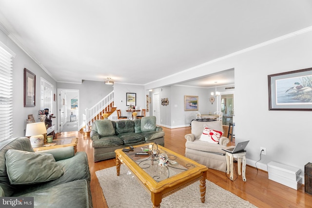 living room with wood-type flooring and ornamental molding