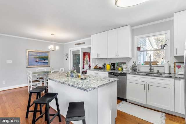 kitchen with white cabinetry, a center island, and light hardwood / wood-style floors