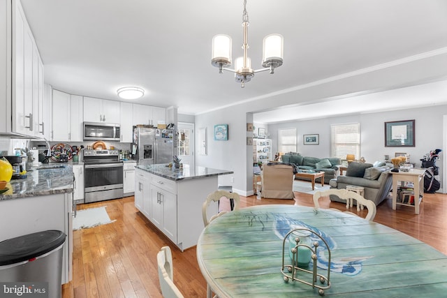 kitchen featuring a kitchen island, light wood-type flooring, white cabinetry, and stainless steel appliances