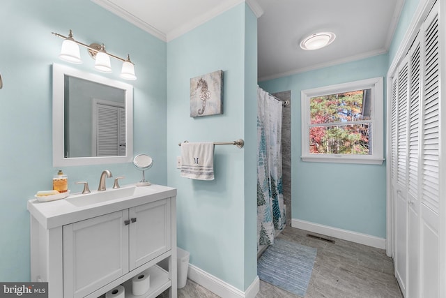 bathroom with curtained shower, hardwood / wood-style floors, vanity, and ornamental molding