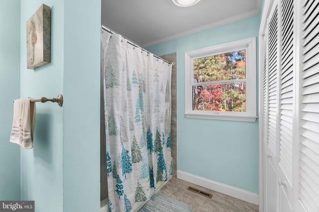 bathroom featuring a shower with shower curtain and ornamental molding