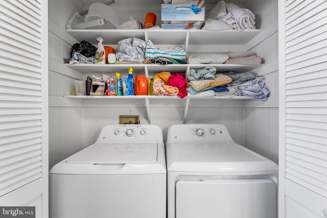 laundry area featuring independent washer and dryer and wooden walls