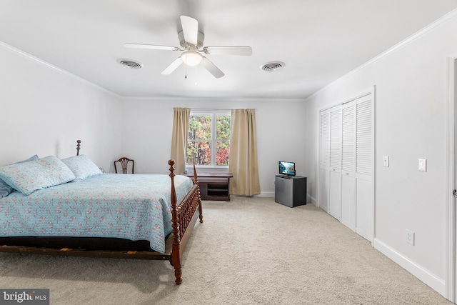 carpeted bedroom featuring ceiling fan, a closet, and ornamental molding