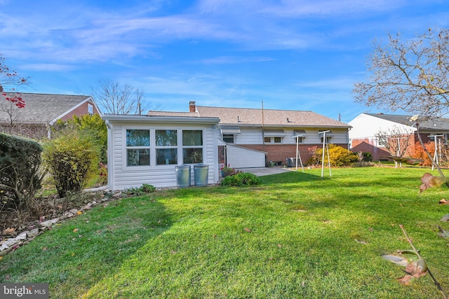 rear view of property with a lawn and a patio area