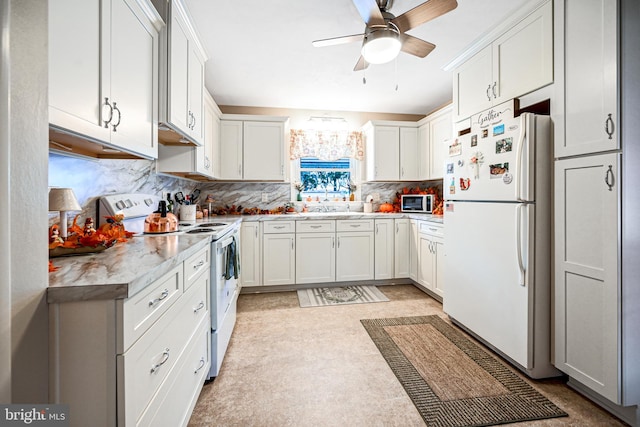 kitchen with white cabinets, ceiling fan, sink, and stainless steel appliances