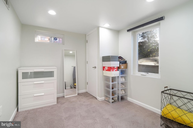 carpeted bedroom featuring multiple windows