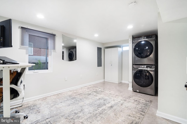 laundry room with stacked washer / dryer and electric panel