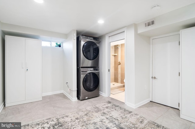 washroom featuring stacked washer and dryer