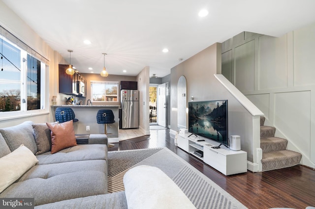 living room featuring dark hardwood / wood-style flooring and sink