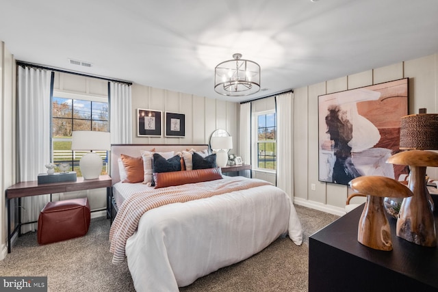 carpeted bedroom featuring a chandelier