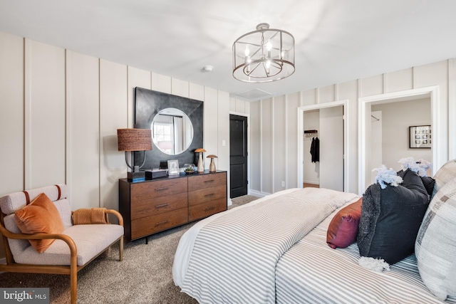 bedroom featuring light colored carpet and a notable chandelier