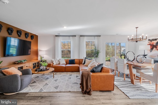 living room featuring a chandelier and light hardwood / wood-style floors