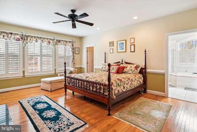 bedroom with wood-type flooring, ensuite bath, and ceiling fan